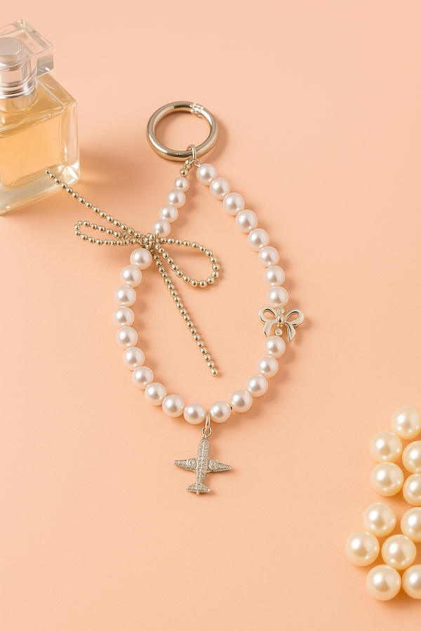 Pearl Phone Charm with Airplane & Bow Design