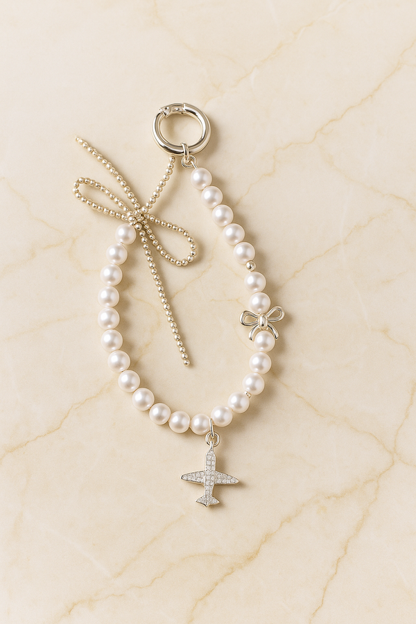 Pearl Phone Charm with Airplane & Bow Design