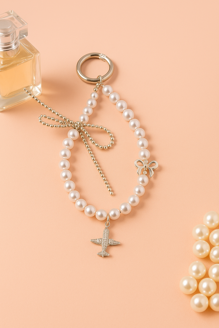Pearl Phone Charm with Airplane & Bow Design